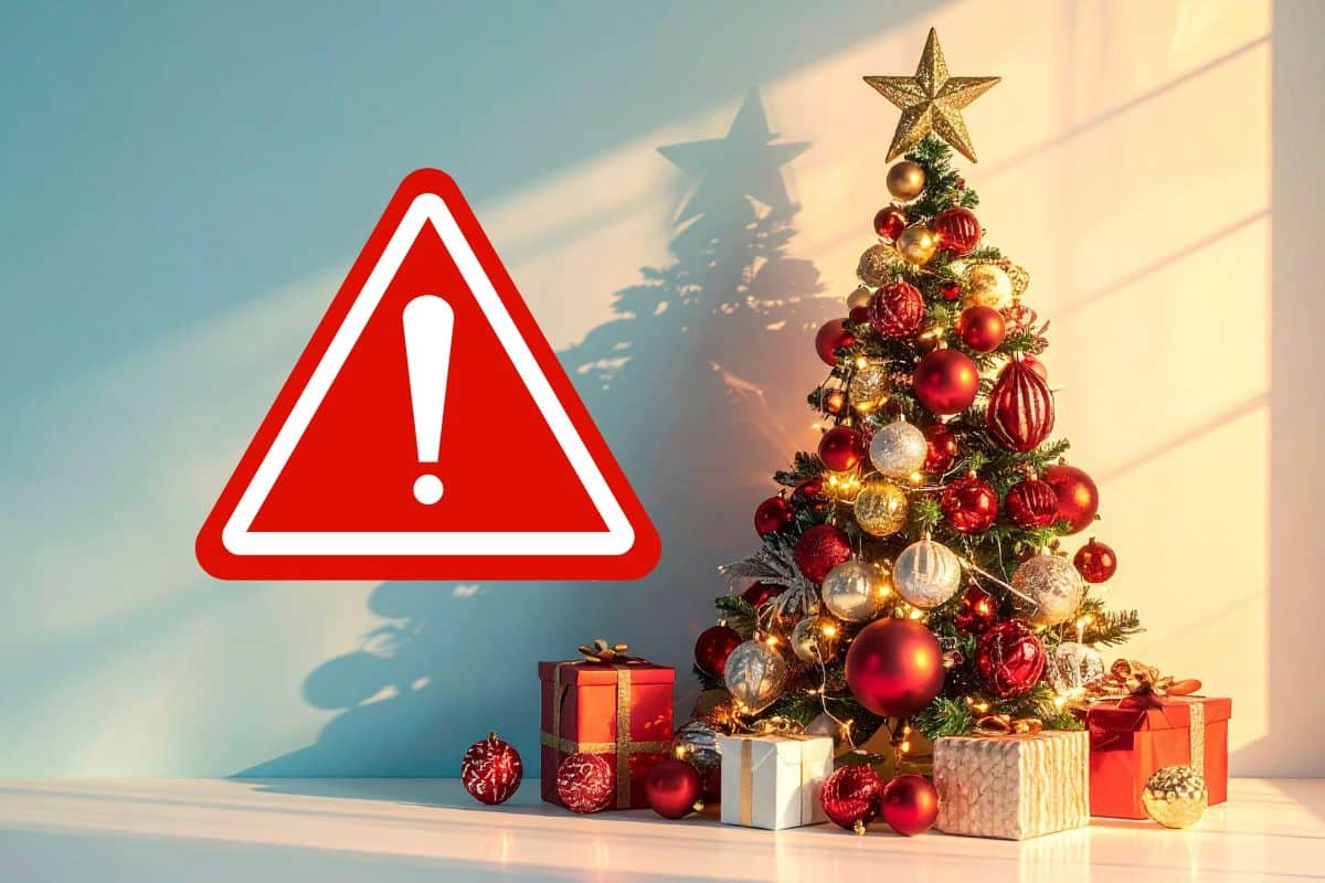 albero di natale addobbato con regali sotto e segnale pericolo